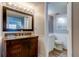 Bathroom featuring a vanity, large mirror and toilet at 10530 77Th Ter # 224, Seminole, FL 33772