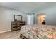 Comfortable bedroom with wood-look flooring, and dresser with mirror at 10530 77Th Ter # 224, Seminole, FL 33772