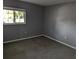 A neutral bedroom with carpeting, window, and clean design offers a peaceful retreat at 10530 77Th Ter # 224, Seminole, FL 33772