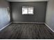 A vacant bedroom features dark flooring, neutral paint, a window, and ample natural light at 10530 77Th Ter # 224, Seminole, FL 33772