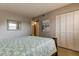 Bedroom with closet and beach-themed wall art over a comfy bed at 10530 77Th Ter # 224, Seminole, FL 33772