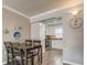 Dining room with wood flooring and kitchen access at 10530 77Th Ter # 224, Seminole, FL 33772
