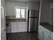 A modern kitchen with white cabinets, stainless steel appliances, and granite countertops offers style and functionality at 10530 77Th Ter # 224, Seminole, FL 33772