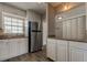 Kitchen featuring a stainless steel refrigerator, granite countertops, and white cabinets at 10530 77Th Ter # 224, Seminole, FL 33772