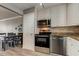 Updated kitchen with stainless steel appliances, white cabinets, and wood flooring at 10530 77Th Ter # 224, Seminole, FL 33772