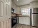 Bright kitchen showcases modern appliances, white cabinets, granite counters, and wood flooring at 10530 77Th Ter # 224, Seminole, FL 33772