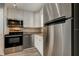 Updated kitchen features stainless steel appliances, white cabinets, and stylish countertops at 10530 77Th Ter # 224, Seminole, FL 33772