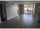 Bright living room showcasing wood floors, sliding glass doors, and neutral paint at 10530 77Th Ter # 224, Seminole, FL 33772