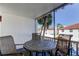 Enclosed patio with palm tree views and seating at 10530 77Th Ter # 224, Seminole, FL 33772