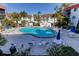 Community pool surrounded by palm trees and lounge chairs perfect for relaxation and enjoyment at 10530 77Th Ter # 224, Seminole, FL 33772