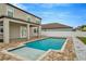 Beautiful in-ground pool and covered outdoor living area, complete with a lovely patio at 11724 Sunburst Marble Rd, Riverview, FL 33579