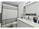 Bathroom featuring a shower with striped curtain, toilet, and vanity with ample counter space at 12738 Wood Trail Blvd, Tampa, FL 33625
