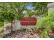 Well-maintained entrance sign for 'Townhomes of Country Wood' amid lush landscaping at 12738 Wood Trail Blvd, Tampa, FL 33625