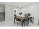 Dining area featuring a table and seating, adjacent to a laundry area at 12738 Wood Trail Blvd, Tampa, FL 33625