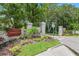 Well-maintained entrance sign for 'Townhomes of Country Wood' amid lush landscaping at 12738 Wood Trail Blvd, Tampa, FL 33625