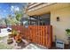 Inviting front yard with a wooden fence and a variety of potted plants at 12738 Wood Trail Blvd, Tampa, FL 33625