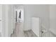 Bright hallway with light wood floors, white walls and doors leading to various rooms at 12738 Wood Trail Blvd, Tampa, FL 33625