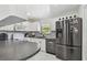 Bright kitchen featuring stainless steel appliances, stone countertops, and tile flooring at 12738 Wood Trail Blvd, Tampa, FL 33625