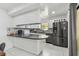 Bright kitchen featuring stainless steel appliances, stone countertops, and tile flooring at 12738 Wood Trail Blvd, Tampa, FL 33625