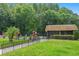 View of the fenced community pool area with palm trees and green lawns at 12738 Wood Trail Blvd, Tampa, FL 33625