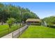 View of the fenced community pool area with palm trees and green lawns at 12738 Wood Trail Blvd, Tampa, FL 33625