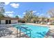 Community pool with blue water, lounge chairs, and a covered area, ideal for relaxation and recreation at 12738 Wood Trail Blvd, Tampa, FL 33625