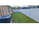 A view of the spacious backyard with a white fence, perfect for outdoor activities at 13052 Ogden Glade Rd, Dade City, FL 33525