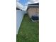 A grass backyard surrounded by a white fence provides privacy and space at 13052 Ogden Glade Rd, Dade City, FL 33525