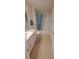 A bright bathroom features a shower-tub combo, toilet, and sink with vanity at 13052 Ogden Glade Rd, Dade City, FL 33525