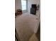bedroom with a window, a dresser, and colorful toy storage at 13052 Ogden Glade Rd, Dade City, FL 33525