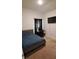 Cozy bedroom with a bed, dark curtains, and a TV for entertainment at 13052 Ogden Glade Rd, Dade City, FL 33525