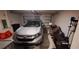 Garage with a silver car and storage at 13052 Ogden Glade Rd, Dade City, FL 33525