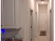 An interior hallway featuring white walls, and a neutral tile floor at 13052 Ogden Glade Rd, Dade City, FL 33525