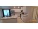 Bright kitchen featuring stainless steel appliances, white cabinets, and an island with sink at 13052 Ogden Glade Rd, Dade City, FL 33525