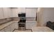 Modern kitchen with stainless steel appliances and white cabinetry at 13052 Ogden Glade Rd, Dade City, FL 33525