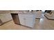 Kitchen island featuring white cabinets and a stainless steel dishwasher at 13052 Ogden Glade Rd, Dade City, FL 33525