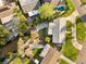 A bird's-eye view captures a home's lush landscaping, private pool, and waterfront access for outdoor living at 1500 Carson Ne Cir, St Petersburg, FL 33703