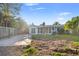 A charming backyard featuring a well-manicured lawn, brick paved driveway, and lush landscaping for outdoor enjoyment at 1500 Carson Ne Cir, St Petersburg, FL 33703