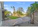 A spacious backyard offering a paved patio, lush greenery, and serene waterfront access at 1500 Carson Ne Cir, St Petersburg, FL 33703