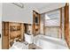 Partially renovated bathroom featuring a white bathtub, toilet, and exposed framing at 1500 Carson Ne Cir, St Petersburg, FL 33703