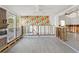 Spacious living room with a brick fireplace, hardwood floors, and an accent wall with colorful wallpaper at 1500 Carson Ne Cir, St Petersburg, FL 33703