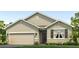 Charming one-story home with a two-car garage, neutral stucco, and green grass at 17210 Wheatberry Blvd, Parrish, FL 34219