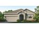 Charming single-story home featuring a neutral color, a two-car garage, and well-maintained landscaping at 17214 Wheatberry Blvd, Parrish, FL 34219