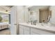 Bathroom featuring double sinks, a large mirror, and a view into the main bedroom at 17267 Whiskey Creek Trl, Parrish, FL 34219