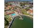 An aerial view showcases a beautiful community with a pool, tennis court, and a dock on the water at 19029 Us Highway 19 N # 12E, Clearwater, FL 33764