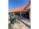 Backyard features a grill and patio set outside the condo's wall of glass windows and a red tile roof at 19029 Us Highway 19 N # 12E, Clearwater, FL 33764