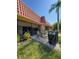 A backyard patio with a brick-paved surface, an outdoor dining set, and a grill at 19029 Us Highway 19 N # 12E, Clearwater, FL 33764