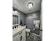 Cozy bathroom with gray walls, an updated vanity, and a shower/tub combo at 19029 Us Highway 19 N # 12E, Clearwater, FL 33764