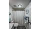 Bathroom featuring a shower-tub combination with gray floors and a toilet at 19029 Us Highway 19 N # 12E, Clearwater, FL 33764
