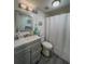 Updated bathroom features a gray vanity and shower-tub combination at 19029 Us Highway 19 N # 12E, Clearwater, FL 33764